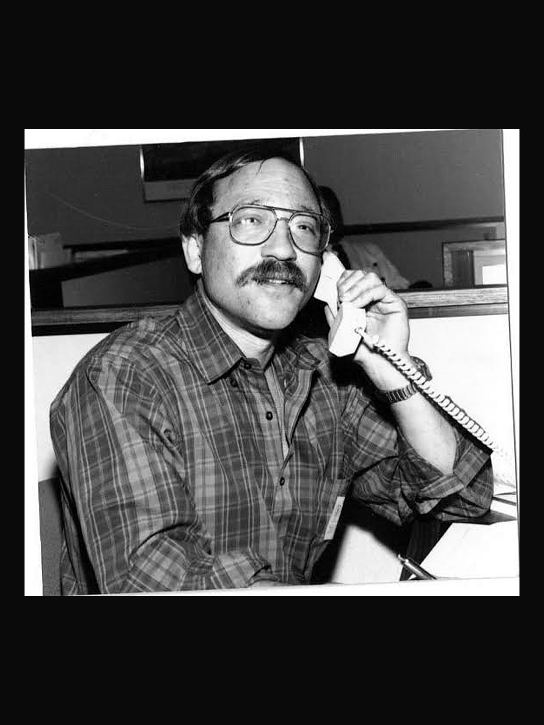 Barry Abell at his desk on the telephone