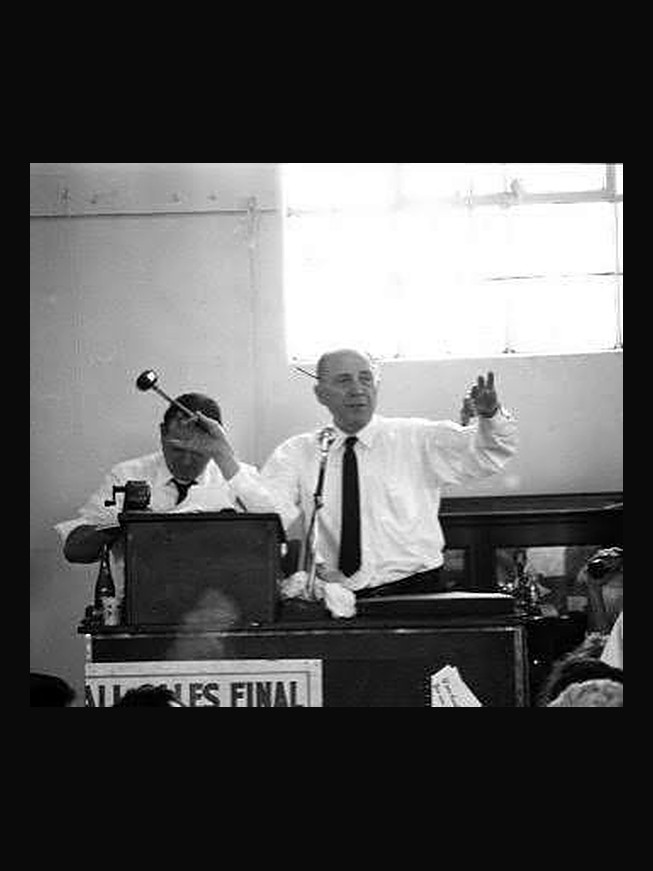 Robert Abell and Abraham N. Abell at the rostrum during a sale, gavel raised