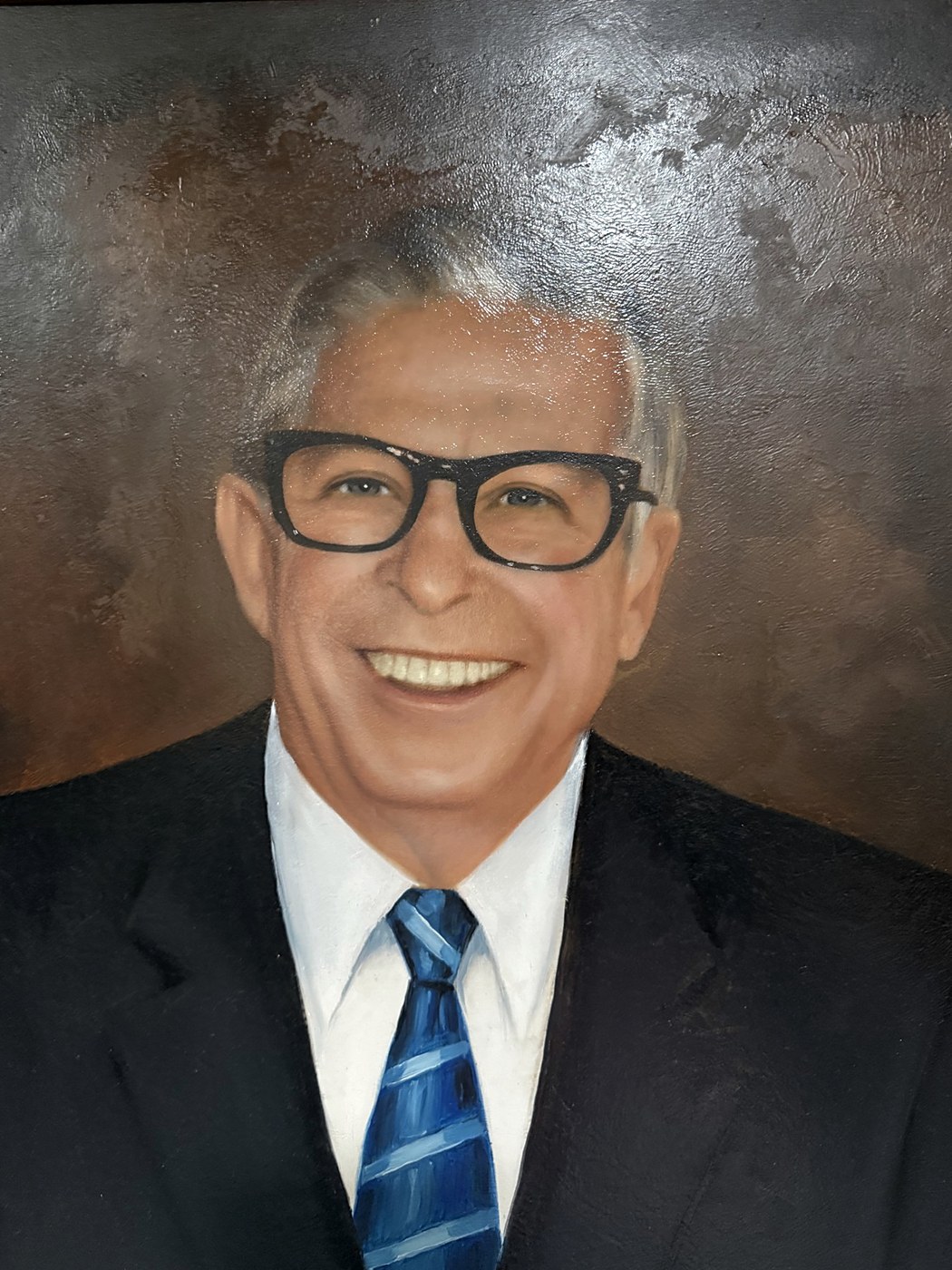 A painted portrait of Willard Schireson in a dark suit and blue striped tie
