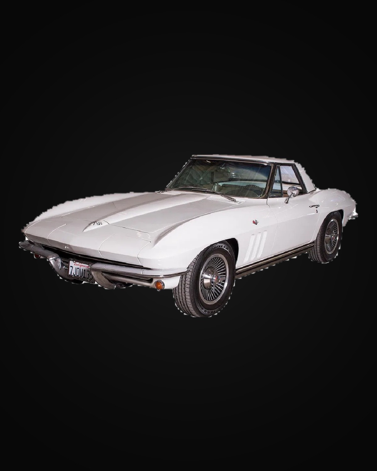A white Chevrolet Corvette Sting Ray convertible with the hardtop fitted