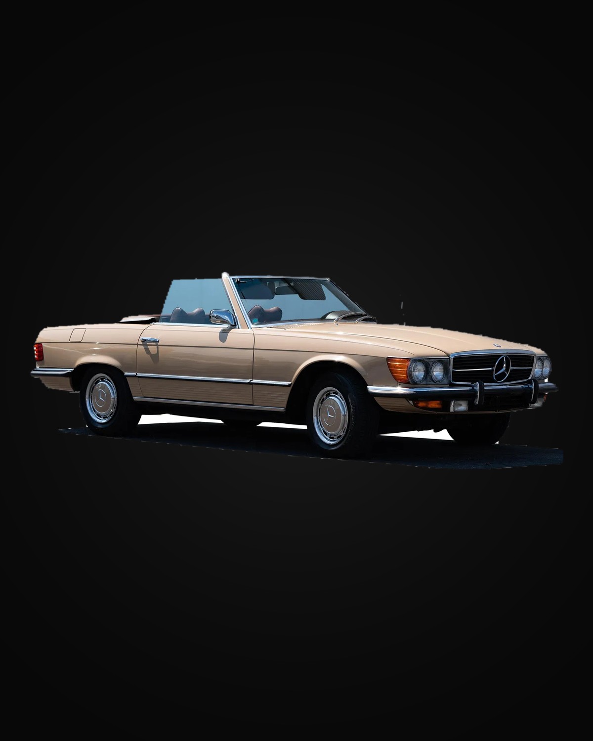 A champagne Mercedes-Benz SL roadster with the top down
