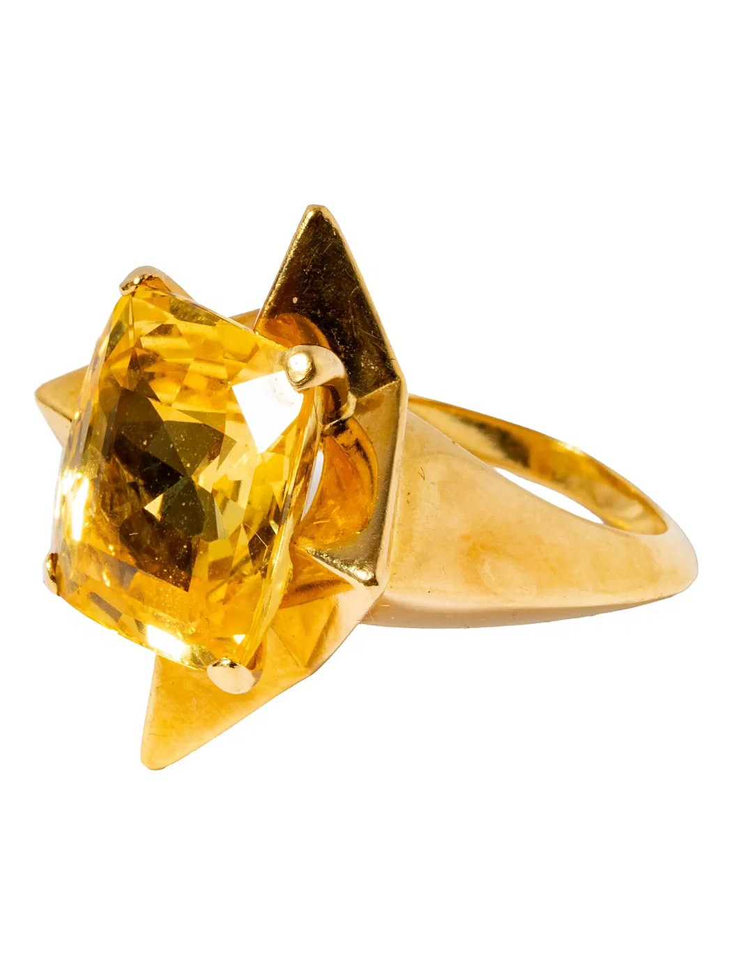 A yellow sapphire ring in a gold star-shaped mount