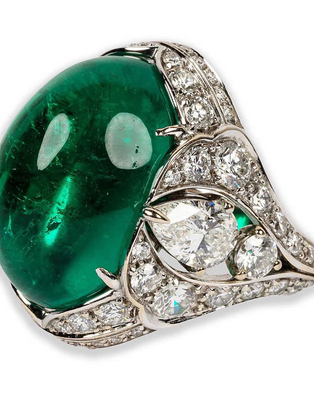 A cabochon emerald ring set with brilliant-cut diamonds in platinum