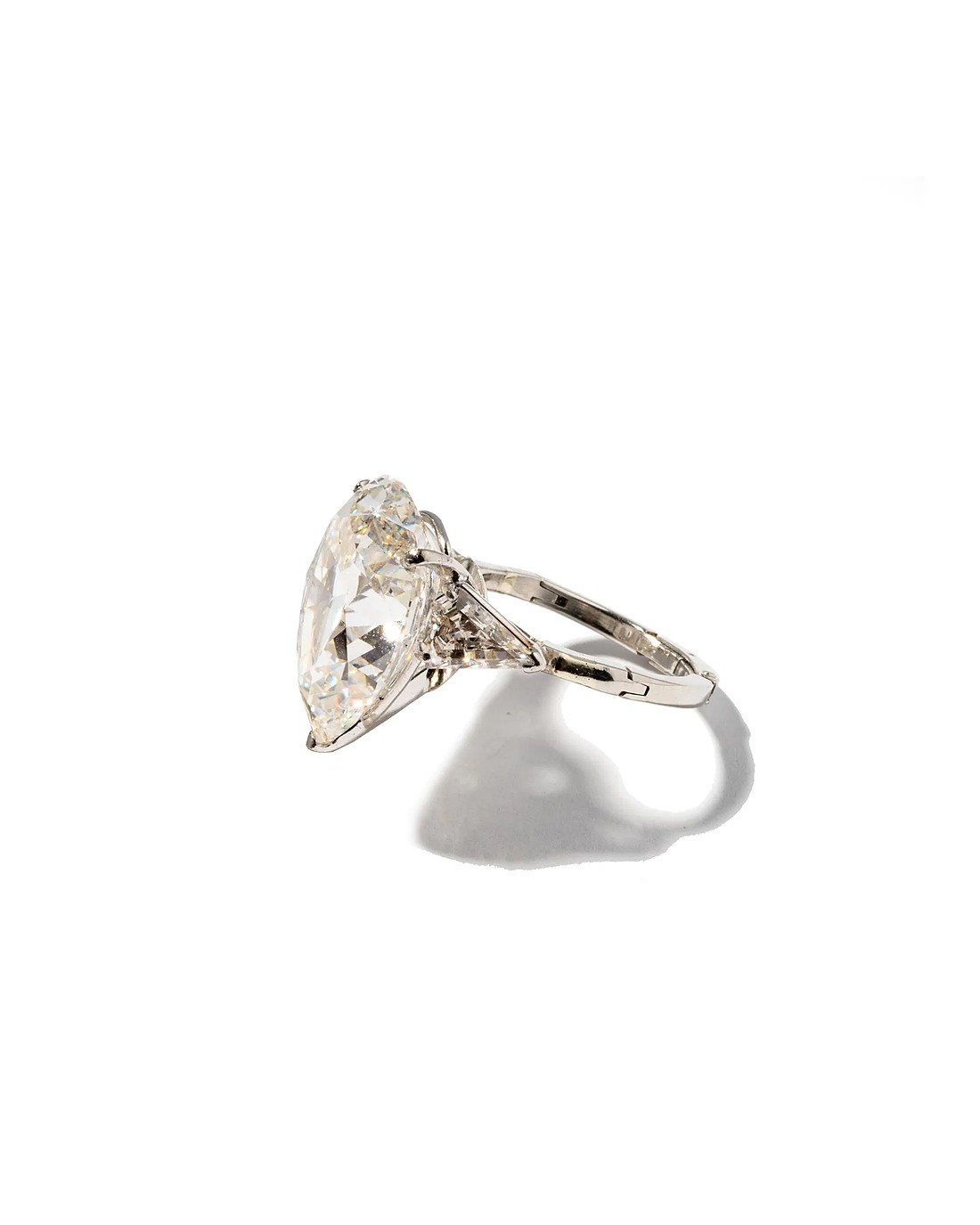 A large pear-shaped diamond in a platinum mount with tapered shoulder stones
