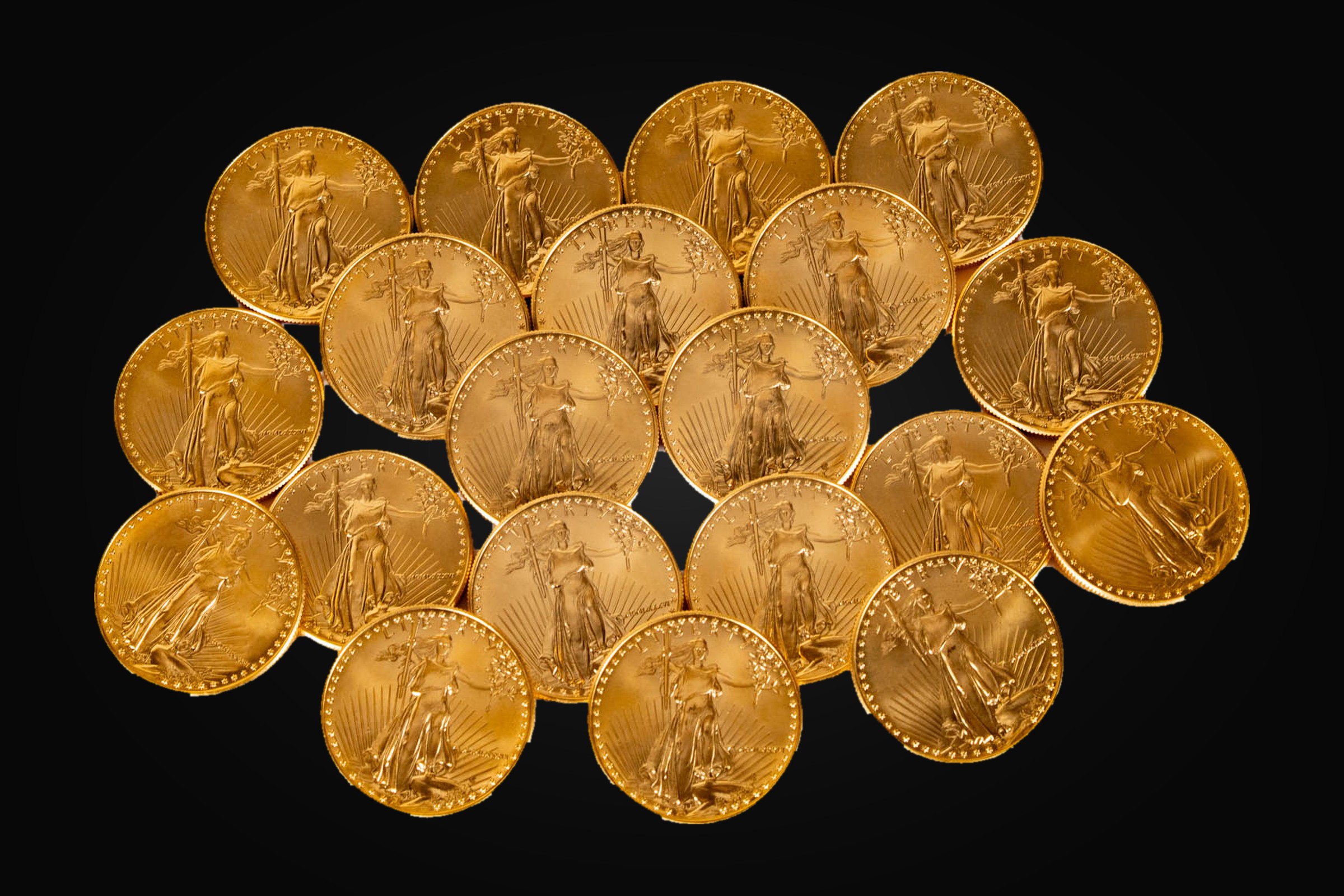 A group of Saint-Gaudens design gold coins, obverse up, on black