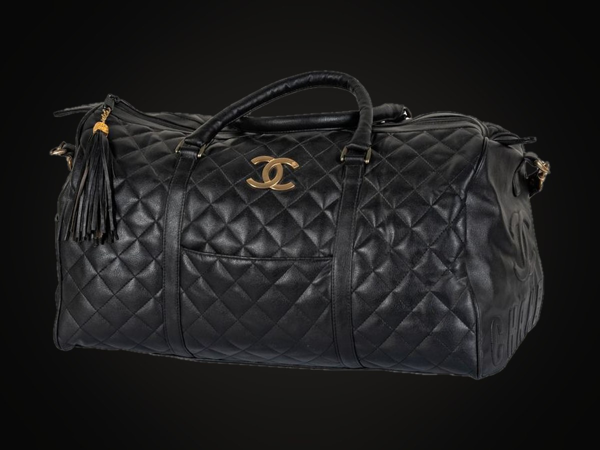 A quilted black leather Chanel duffle with tassel and interlocking CC