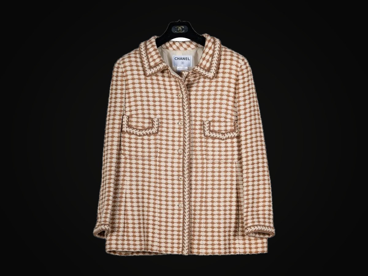 A Chanel houndstooth tweed jacket in ecru and camel, on its Chanel hanger