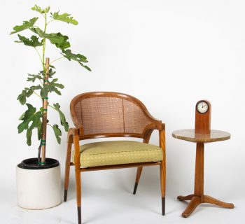 A Dunbar cane back bergere and granite occasional table from the Cullen estate will be sold on September 27th at Abell Auction Co. in Los Angeles.